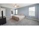 Serene bedroom featuring soft grey walls, plush carpeting, and a ceiling fan, creating a comfortable retreat at 3010 Underwood Ct, Whiteland, IN 46184