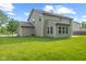 Exterior view of the home's spacious backyard features lush green lawn and mature trees at 3068 Reflection Ct, Greenwood, IN 46143