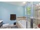 This bathroom includes ceramic tile flooring, a soaking tub, and separate shower with glass door at 3068 Reflection Ct, Greenwood, IN 46143