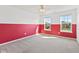 This bedroom features carpeting, ample natural light, and white-and-red accent wall at 3068 Reflection Ct, Greenwood, IN 46143