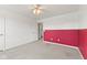 The bedroom has carpeting, and white-and-red accent wall, and access to the laundry room at 3068 Reflection Ct, Greenwood, IN 46143