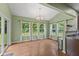 Bright dining area with large windows, wood floors, and access to the backyard at 3068 Reflection Ct, Greenwood, IN 46143