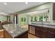 Open-concept kitchen features an island, stainless steel appliances, and a view to the backyard through sliding glass doors at 3068 Reflection Ct, Greenwood, IN 46143