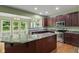 Updated kitchen features a center island, stainless steel appliances and views to the breakfast nook and backyard at 3068 Reflection Ct, Greenwood, IN 46143