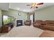 Comfortable living room with a cozy fireplace, plush seating, and ceiling fan at 3068 Reflection Ct, Greenwood, IN 46143