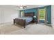 The main bedroom features beautiful blue accent wall, a ceiling fan, and plenty of natural light at 3068 Reflection Ct, Greenwood, IN 46143