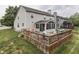 Back exterior view featuring deck, sunroom, and expansive lawn at 3714 Turfway Ct, Indianapolis, IN 46228