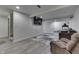 Finished basement with a large screen television and plush seating area at 3714 Turfway Ct, Indianapolis, IN 46228