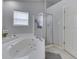 Bright bathroom featuring a jetted tub and a glass shower at 3714 Turfway Ct, Indianapolis, IN 46228