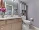 Charming bathroom with a neutral-colored vanity, toilet and decorative accents at 3714 Turfway Ct, Indianapolis, IN 46228