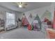 Bright bedroom with a mountain mural, a ceiling fan, and a sunny window at 3714 Turfway Ct, Indianapolis, IN 46228