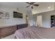 A generous primary bedroom boasts an ensuite bathroom, built in dressers, and large flat-screen television at 3714 Turfway Ct, Indianapolis, IN 46228