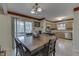 Open dining area with traditional cabinets, table, and view of the enclosed patio at 3714 Turfway Ct, Indianapolis, IN 46228