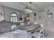 Open-concept dining area with seating for six, modern lighting, and decorative wall art at 3714 Turfway Ct, Indianapolis, IN 46228