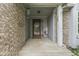 Covered entryway with brick accents, a welcoming door, and decorative plants at 3714 Turfway Ct, Indianapolis, IN 46228