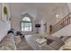 Bright living room features vaulted ceilings, staircase, and comfortable seating area at 3714 Turfway Ct, Indianapolis, IN 46228