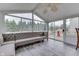 Relaxing sunroom with large windows offering scenic views and comfortable seating at 3714 Turfway Ct, Indianapolis, IN 46228