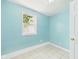 Light-filled bedroom featuring light blue walls and tile flooring at 4020 N Mitthoefer Rd, Indianapolis, IN 46235