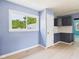 Cozy dining area with light blue walls and view into kitchen area at 4020 N Mitthoefer Rd, Indianapolis, IN 46235