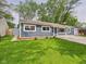 Charming single-story home with a well-maintained green lawn at 4020 N Mitthoefer Rd, Indianapolis, IN 46235