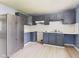 Spacious kitchen with grey cabinets, light countertops and stainless steel appliances at 4020 N Mitthoefer Rd, Indianapolis, IN 46235