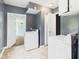 Laundry room featuring tile floors and a white washer and dryer set at 4020 N Mitthoefer Rd, Indianapolis, IN 46235