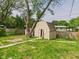 Backyard shed situated on a manicured lawn, offering ample storage space and blending seamlessly with the landscape at 4020 N Mitthoefer Rd, Indianapolis, IN 46235