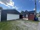 View of backyard featuring garage and fenced yard with an access gate to the backyard and home at 421 W Hendricks St, Shelbyville, IN 46176