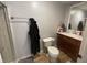 Well-lit bathroom features wood-look flooring, a framed mirror, and vanity with storage at 421 W Hendricks St, Shelbyville, IN 46176