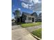 Attractive two-story home with a welcoming front porch, manicured lawn, and mature trees for comfortable living at 421 W Hendricks St, Shelbyville, IN 46176