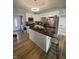 Bright kitchen featuring modern white cabinets, stainless appliances, and island with seating at 421 W Hendricks St, Shelbyville, IN 46176