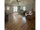Cozy living room featuring vaulted ceiling, plush furniture, and ample natural light at 421 W Hendricks St, Shelbyville, IN 46176