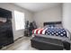 Bedroom with wooden floors, TV, and American flag throw blanket at 4342 Sequoia Ct, Greenwood, IN 46143