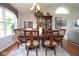 Open dining area with a large dining table, chandelier, and backyard views at 4342 Sequoia Ct, Greenwood, IN 46143