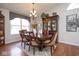 Bright dining room with hardwood floors, modern chandelier, and a large china cabinet at 4342 Sequoia Ct, Greenwood, IN 46143
