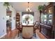 Well-lit dining area with hardwood floors, elegant furniture and backyard views at 4342 Sequoia Ct, Greenwood, IN 46143
