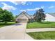 Beautiful home with a lush green lawn, mature trees, and a paved driveway leading to the garage at 4342 Sequoia Ct, Greenwood, IN 46143