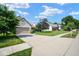 Residential home with a well-manicured lawn, trees, and a long driveway leading to the garage at 4342 Sequoia Ct, Greenwood, IN 46143