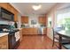 Bright kitchen features wood cabinets, modern appliances, and wood flooring at 4342 Sequoia Ct, Greenwood, IN 46143