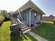 Corner of the house with gray siding, deck, and green grass at 4402 E New York St, Indianapolis, IN 46201