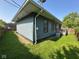 Exterior view of the back of the house with gray siding and lawn at 4402 E New York St, Indianapolis, IN 46201