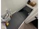 Stairway leading to a finished basement with gray painted steps at 4402 E New York St, Indianapolis, IN 46201