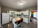 Bright kitchen with white cabinets and a colorful island, offering a functional and creative space at 4402 E New York St, Indianapolis, IN 46201