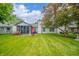 Expansive backyard featuring lush green grass, mature trees, screened-in porch, and outdoor seating area at 441 E Pine Ridge Dr, Westfield, IN 46074