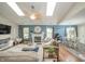 Spacious living room featuring a fireplace, skylights, a ceiling fan, and views of the dining area at 441 E Pine Ridge Dr, Westfield, IN 46074