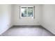 Empty bedroom with neutral carpet and a window offering a view of the outdoors at 4462 Carya Sq, Columbus, IN 47201