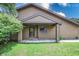 Front door and porch with mature greenery and lawn in the front yard at 4462 Carya Sq, Columbus, IN 47201