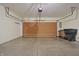 Spacious garage with an automatic door opener, concrete floor, and trash bins at 4462 Carya Sq, Columbus, IN 47201