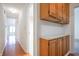 Hallway with hardwood floors, built-in cabinets, and access to multiple rooms at 4462 Carya Sq, Columbus, IN 47201