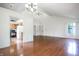 Bright living space showing an open kitchen layout and hardwood flooring at 4462 Carya Sq, Columbus, IN 47201
